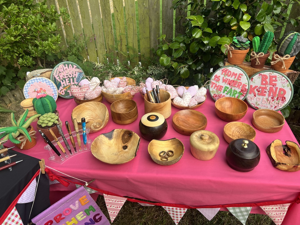 A colourful display of sewn goods and turned wooden pieces