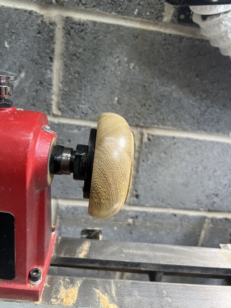 The outside of the bowl shaped and sanded on the lathe