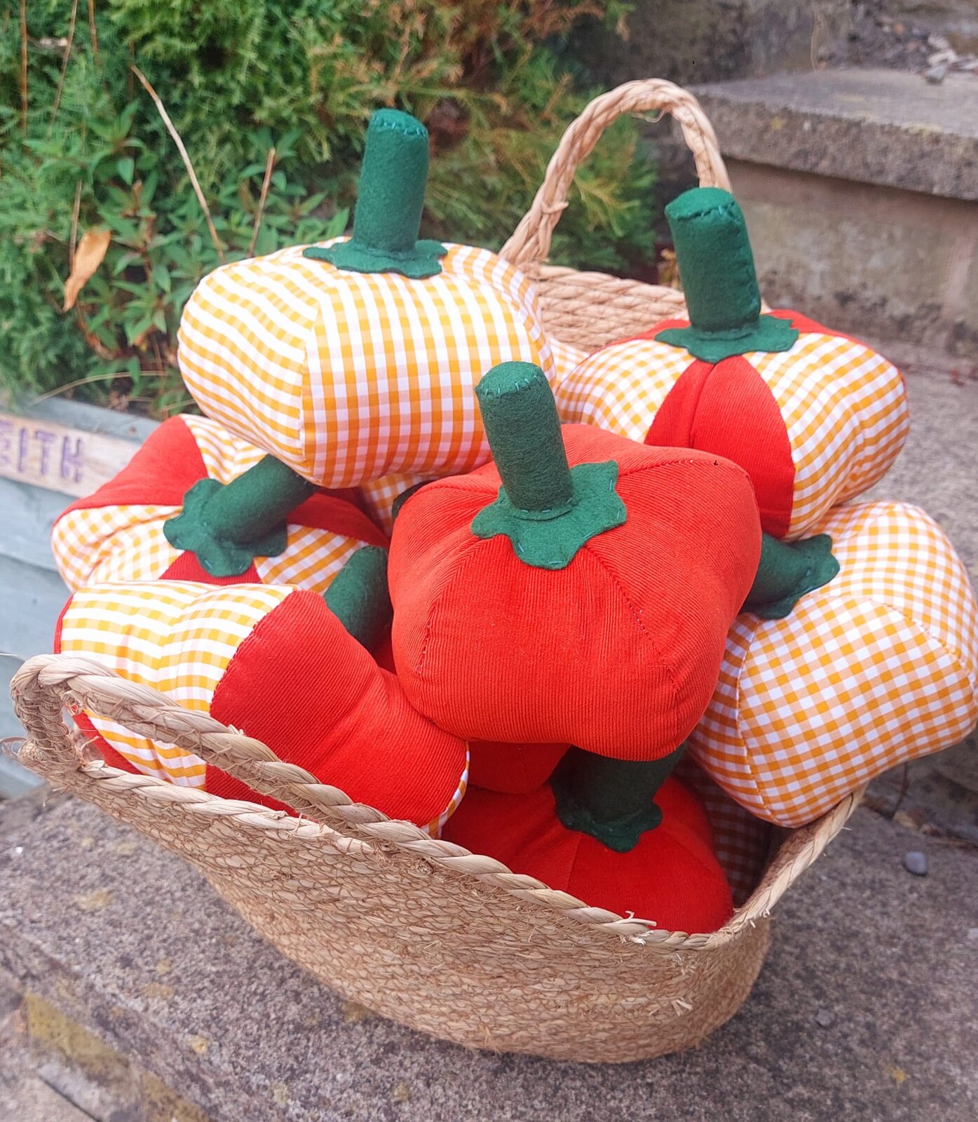 A basket full of gingham and corduroy fabric pumpkins
